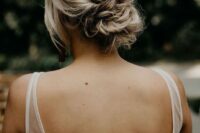 a chic and messy twisted low bun with a textured top and face-framing locks is a cool idea for a wedding, it’s timeless classics