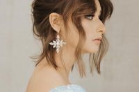 a chic messy top knot with a messy bump on top, face-framing hair is a chic and stylish idea for a wedding