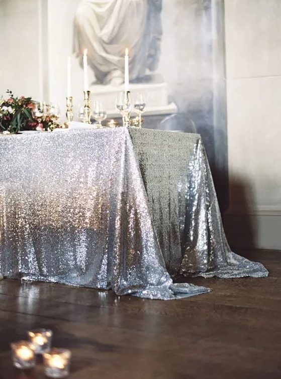 a chic silver sequin tablecloth and gold accents for a glam wedding table setting