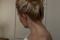 a classic messy and wavy top knot, messy and wavy hair are a fresh and modern idea for a modern wedding  look
