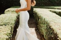 a classic plain strapless mermaid wedding dress with a train and a row of buttons on the back is a lovely idea for a modern romantic bride