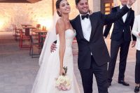 a classic strapless plain wedding ballgown with a train and a veil are a cool and chic combo for a glam and formal wedding