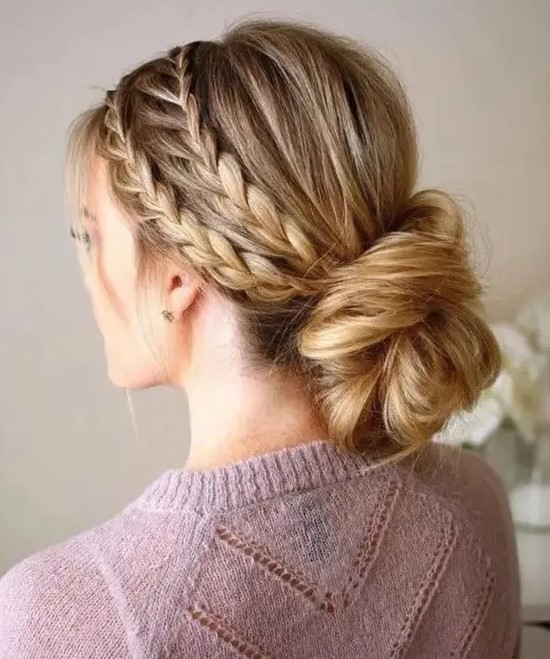 a double braided halo with a low twisted low bun guarantees a picture-perfect look for the whole day