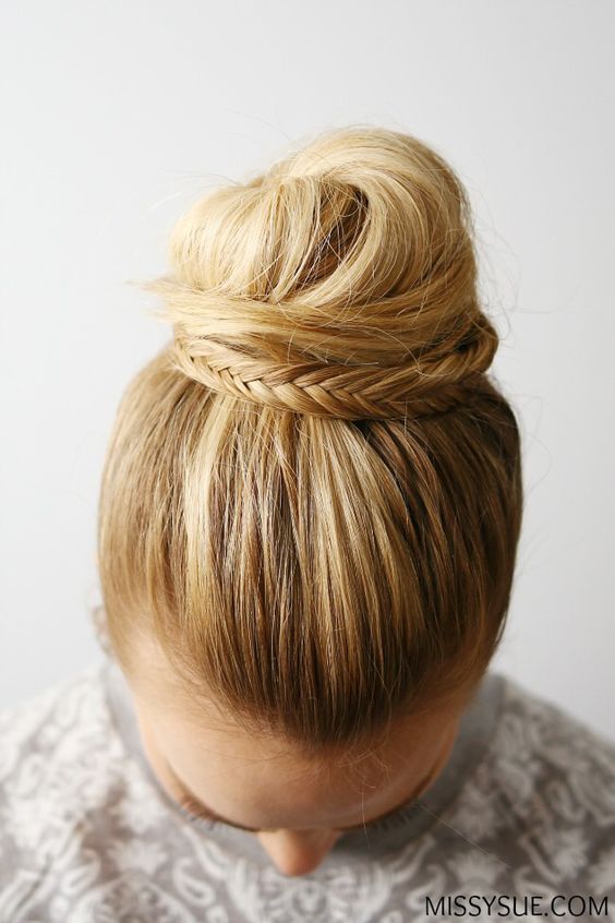 a fishtail braid embellished top knot with a sleek top will be a cool and catchy idea for a boho or rustic wedding