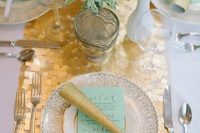 a gold chunky sequin table runner is amazing to spruce up a wedding tablescape in white and aqua