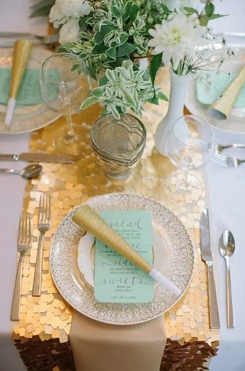 a gold chunky sequin table runner is amazing to spruce up a wedding tablescape in white and aqua