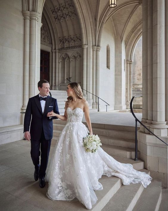 a gorgeous lace applique strapless wedding ballgown with a full skirt and a train is perfect for a refined formal wedding