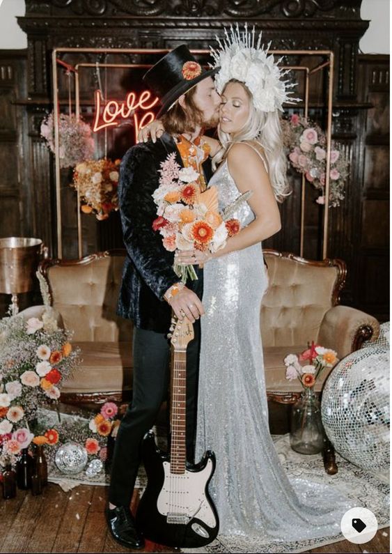 a jaw-dropping silver sequin slip wedding dress with a train and a floral crown is bold and catchy solution