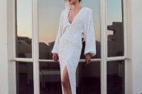 a luxurious white sequin wedding dress with a deep V-neckline, a thigh high slit, white shoes and statement accessories