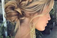 a messy boho low bun with a messy volume on top, a braided halo, some locks down looks very stylish and bold