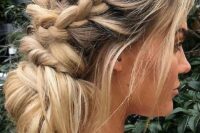 a messy low bun with a textural bump and braids on two sides plus hair down is a casual idea