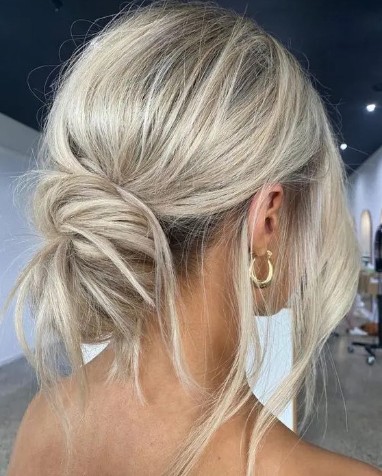 a messy low bun with a volume on top and some locks down is a perfect solution for a casual or boho wedding