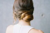 a modern low bun with a bump and locks down is a refined and elegant hairstyle for a minimalist bride