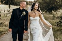 a modern strapless mermaid wedding dress with a corset, lace applique and a train, a veil is a stylish and glam idea to rock