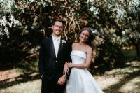 a modern strapless wedding ballgown with a thigh high slit and a train and white shoes are a perfect modern combo for a wedding