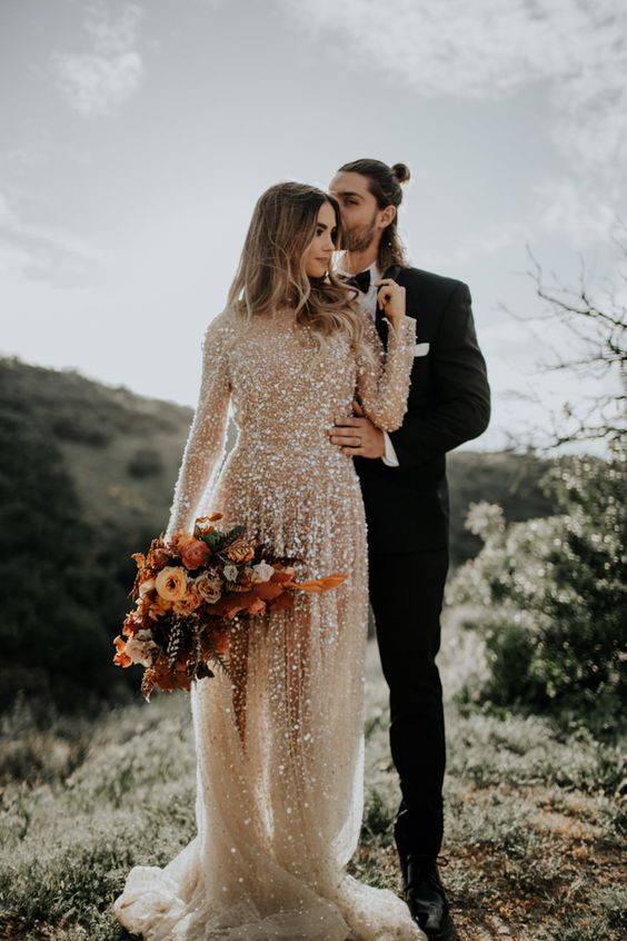 a neutral sequin wedding dress with sheer parts, a high neckline and long sleeves is a super shiny and glam idea