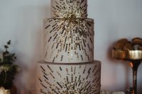 a neutral wedding cake with gold edible sequin is a catchy and chic solution to rock