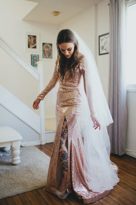 a pink sequin wedding dress with a thigh high slit, a train and a cathedral veil for a glam and edgy look