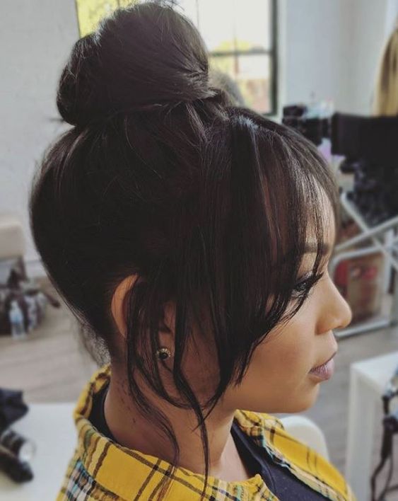 a pretty classic top knot with face-framing hair is always a good idea that will match many bridal looks