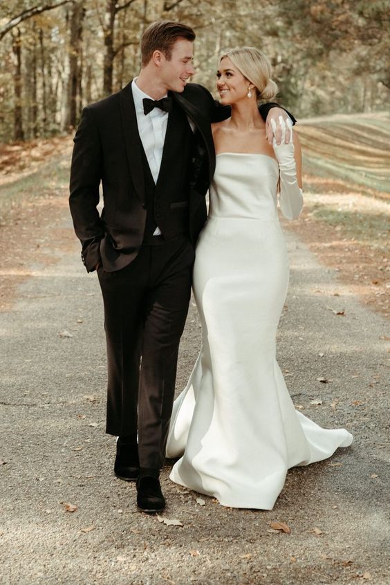 a silk strapless mermaid wedding dress with a train and matching long gloves are a cool combo for a wedding