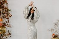 a silver sequin mermaid wedding dress with puff sleeves and a train is a super chic and unusual solution for a 70s wedding