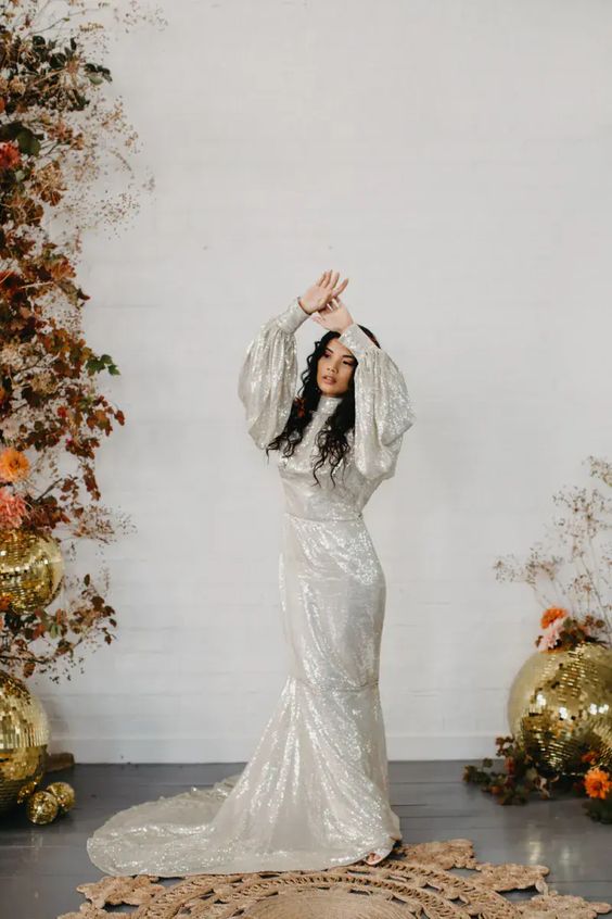 a silver sequin mermaid wedding dress with puff sleeves and a train is a super chic and unusual solution for a 70s wedding