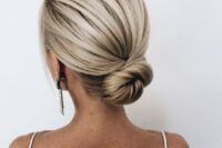 a sleek low bun with a bump is a cool idea is a great option for a minimalist or modern bride