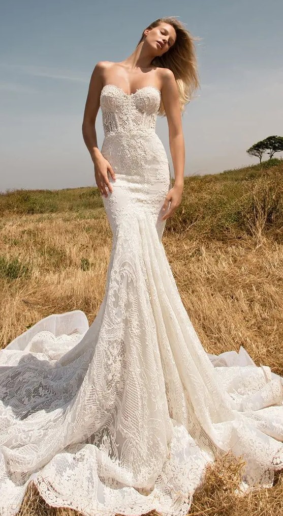 a strapless boho lace mermaid wedding dress with a train looks very chic and sexy