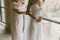 a strapless embellished wedding dress with a lace trim and a long veil is a beautiful solution for a modern romantic bride