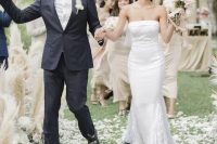 a strapless plain mermaid wedding dress with feather detailing is a catchy and bold modern wedding idea