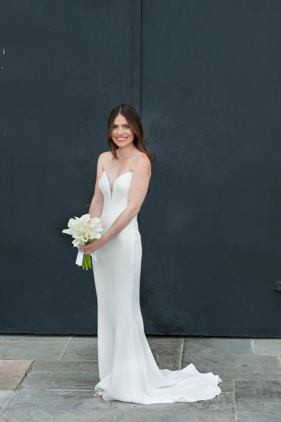 a strapless plain sheath wedding dress with a plunging neckline and a train is very elegant