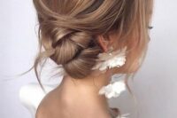 a stylish and elegant side twisted bun with a volume on top, some locks down and a bit of mess for a gorgeous look