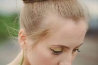 a top twisted knot with a braid around it and with a sleek top is a cool and catchy take on a traditional knot