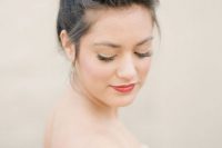 a unique wedding hairstyle that consists of a braided top and a braid wrapped around the top knot is all cool