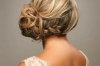 a wavy braided side bun with a textural volume on top is a chic and stylish idea for a bit of edge