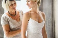 a white sequin spaghetti strap sheath wedding dress features a traditional bridal color and a sexy design