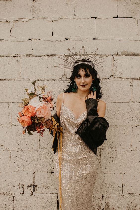 an edgy bridal look with a gold sequin spaghetti strap wedding dress, a leather jacket and a burst tiara is amazing
