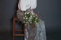 an edgy bridal look with a white blouse, a silver sequin maxi skirt and a bold makeup is a chic and catchy solution