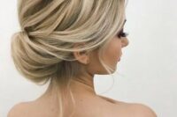 an elegant twisted low bun with a volume on top and some locks down is a timelessly chic and cool hair idea