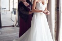 an eye-catchy and chic strapless wedding ballgown with a corset bodice and a train is a very chic and lovely idea