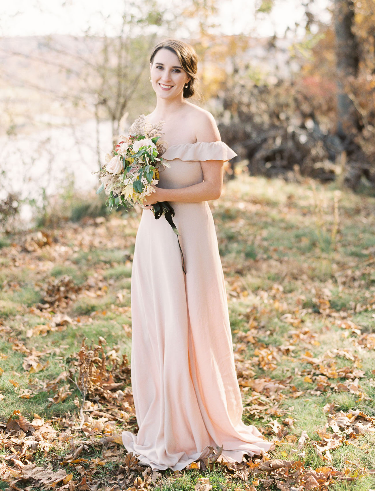 The bride was wearing a blush off the shoulder fitting dress, an updo and statement earrings
