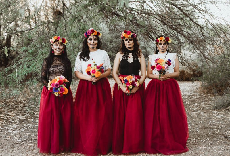 The bridesmaids were wearing layered red tulle skirts and white and black lace tops, plus bright floral crowns