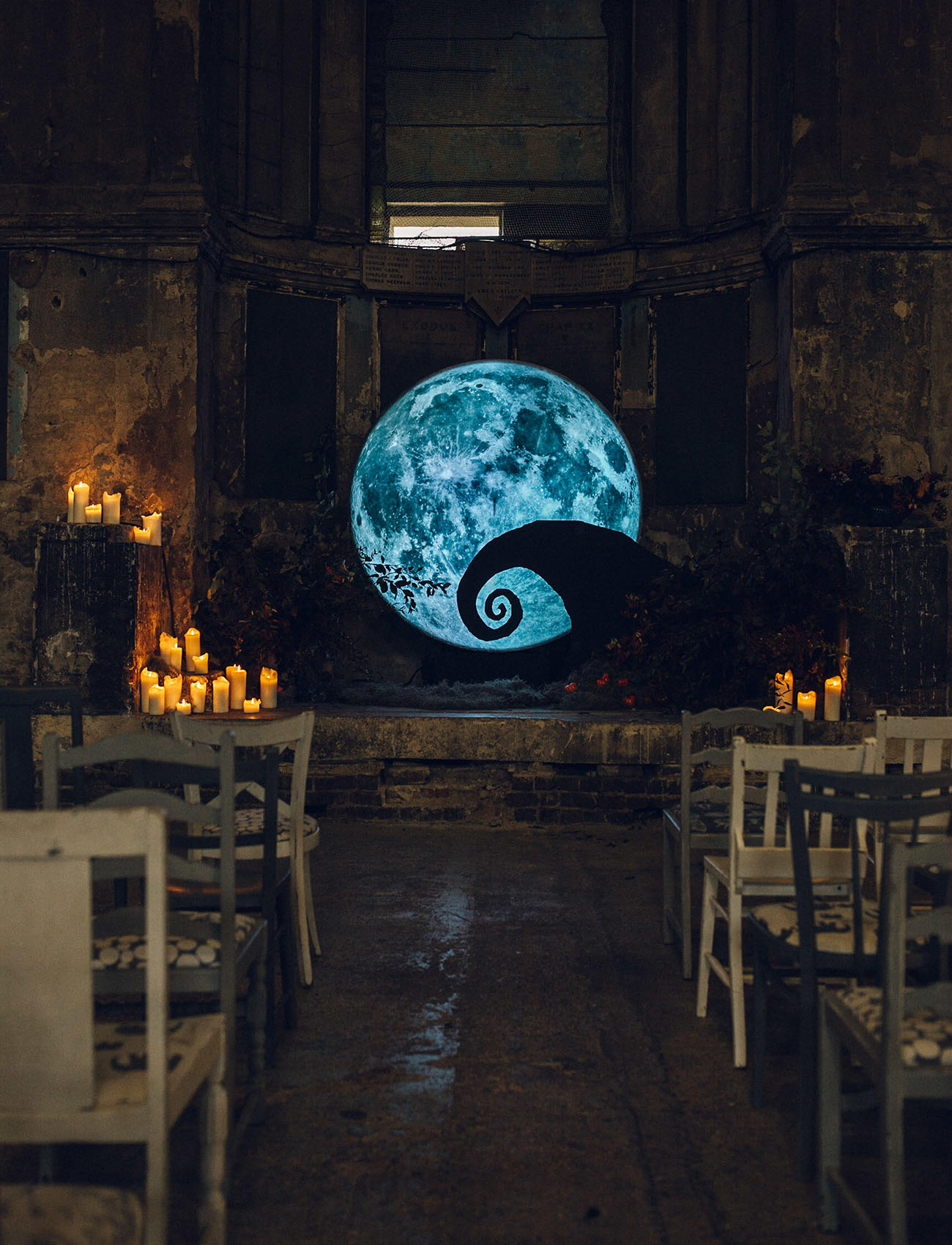 The wedding backdrop was really inspired by the movie, it looks spooky and very styled, and candles around create a mood