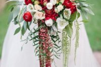 02 a cascading Christmas wedding bouquet of red and white blooms, foliage and berries and bright ribbons
