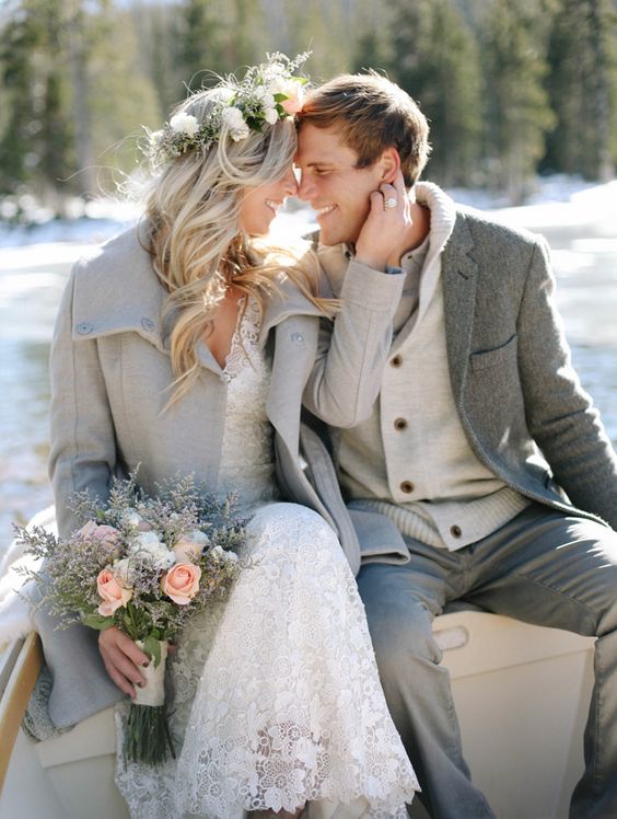 a dove grey coat for the bride, a grey jacket and pants for the groom and touches of cream