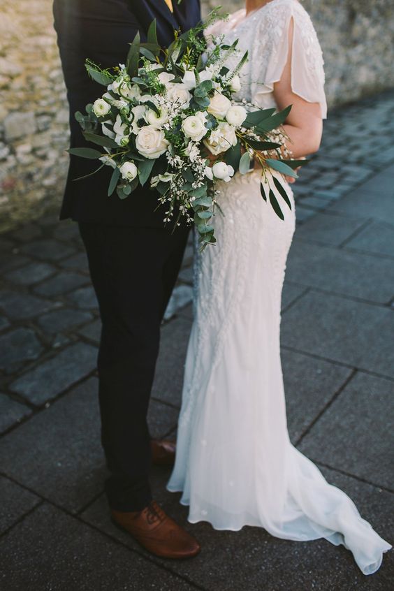 a lush white winter wedding bouquet with greenery is a chic and timeless idea for every bride