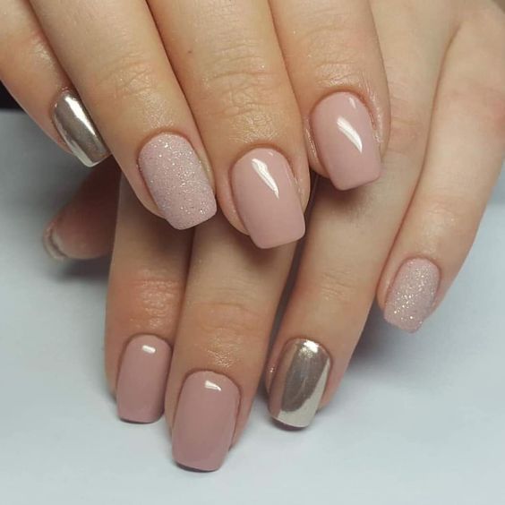 a nude manicure with a touch of glitter and silver nails for those who still insist on classics