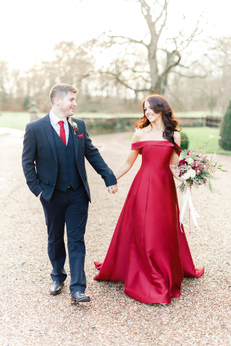 a red off the shoulder A-line wedding gown with a train is a gorgeous statement for a Christmas wedding