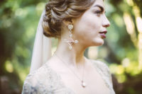 03 The bride was rocking statement earrings and a chic twisted updo plus a dark lip
