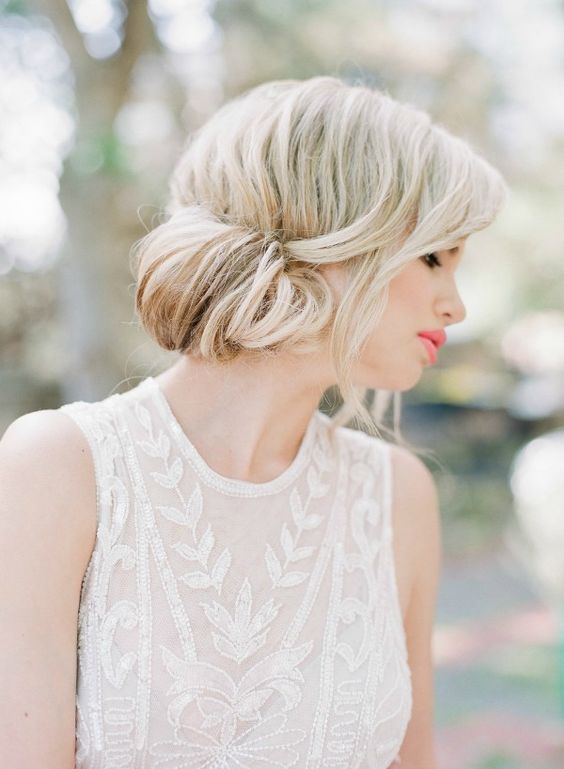 a chic side low updo with locks down is a chic solution for a modern romantic bride ad is rather long-lasting, fitting even shoulder length hair